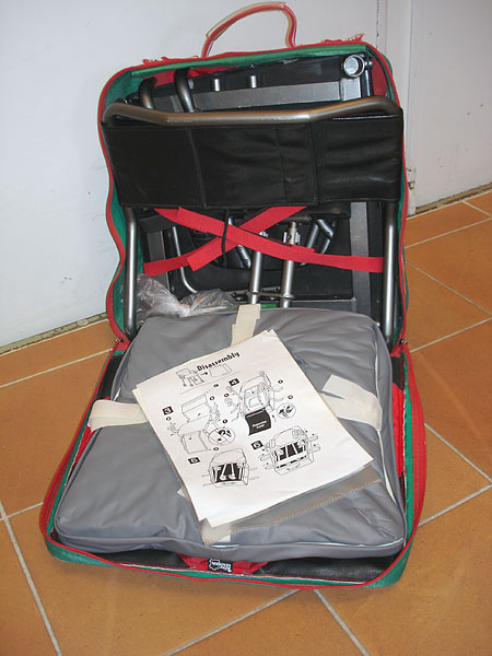 Shower chair carrying case, open; the parts of the showerchair are visible.